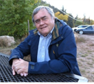 man with gray hair posing and smiling